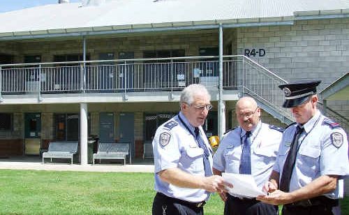 Prison general manager Trevor Craig, deputy manager Peter Drage and Raymond Noonan in front of the residential unit that two drunken prisoners decided to climb on Wednesday night. Prison general manager Trevor Craig, deputy manager Peter Drage and Raymond Noonan in front of the residential unit that two drunken prisoners decided to climb on Wednesday night.